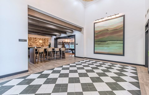 the tasting room has a checkered floor and a painting on the wall